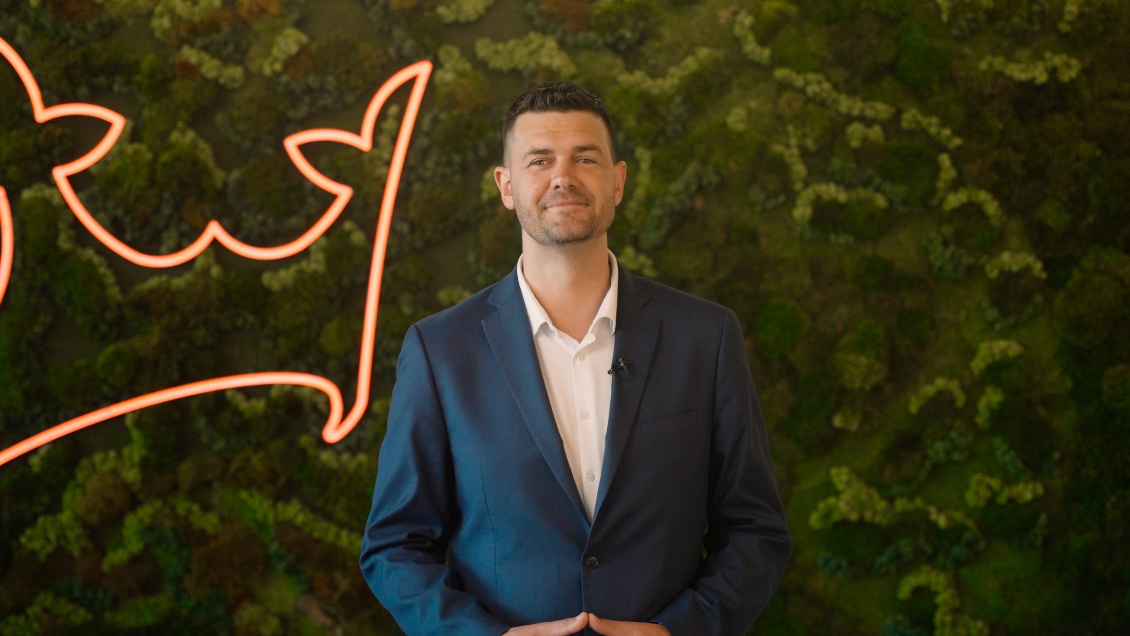 Corporate portrait against a red background
